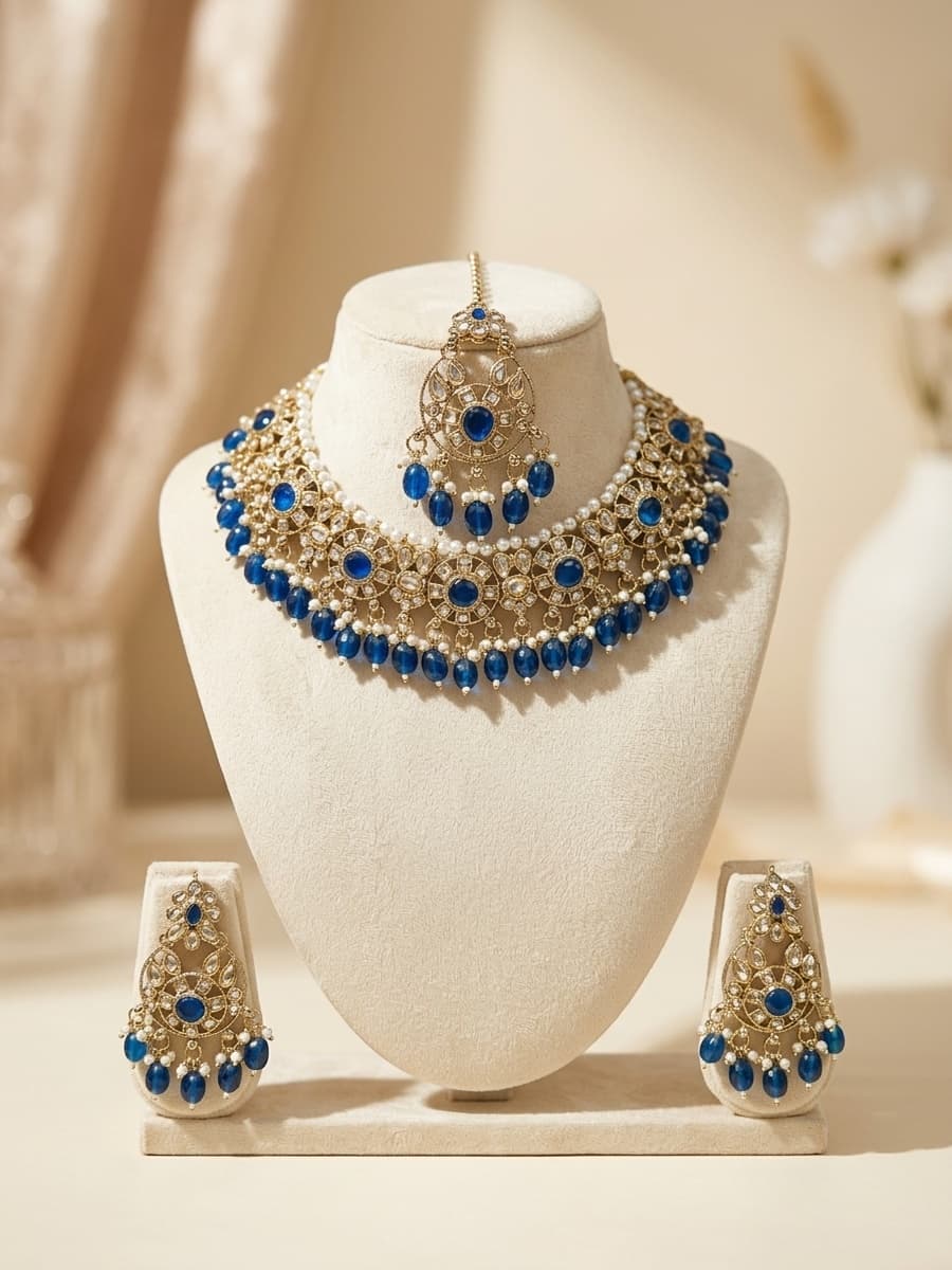 Royal Blue Gemstone and Polki Choker with Matching Tikka and Chandelier Earrings on Ivory Bust